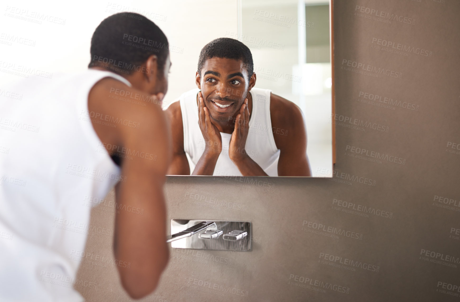 Buy stock photo A young man washing his face