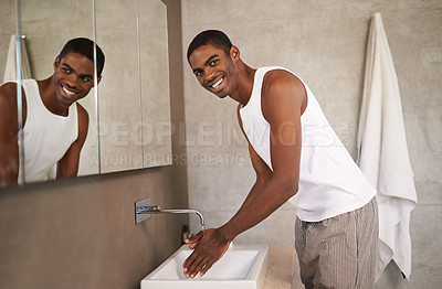 Buy stock photo A young man washing his hands