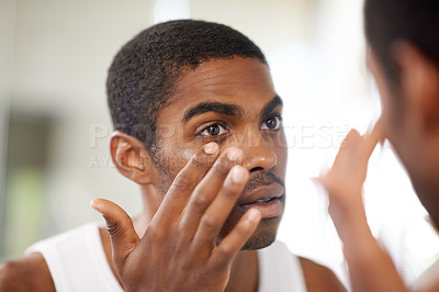Buy stock photo Face, skincare and lotion with black man in bathroom mirror of home to apply antiaging treatment. Beauty, cream and cosmetics with reflection of young person in apartment for skin moisturizer