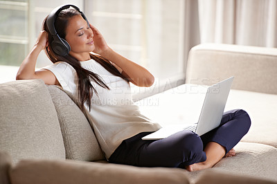 Buy stock photo Headphones, laptop and woman on a home sofa listening to music or audio while streaming online. Calm female person relax on couch to listen to radio or song with internet connection and technology