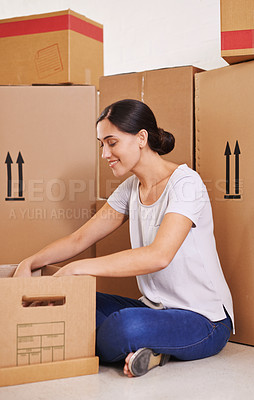 Buy stock photo A young woman surrounded by boxes