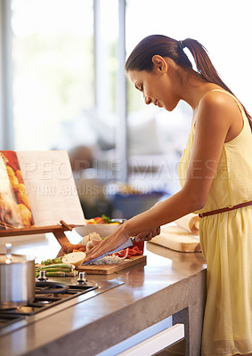 Buy stock photo Cooking, kitchen and woman cutting ingredients for healthy, wellness and nutrition meal at home. Food, diet and female person chopping vegetables for lunch, dinner or supper on counter in apartment.