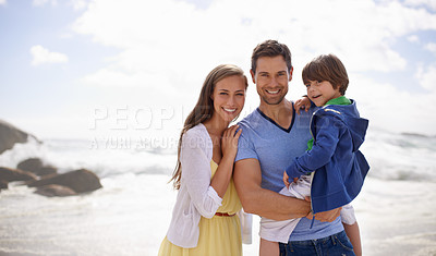 Buy stock photo Portrait of a happy family standing together on the beach