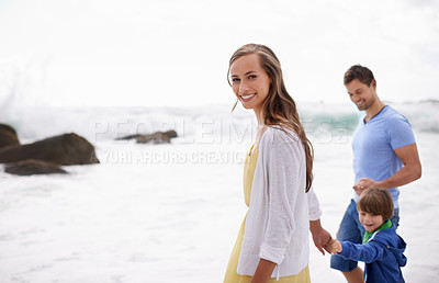Buy stock photo Portrait of an attractive young woman walking along the beach with her family