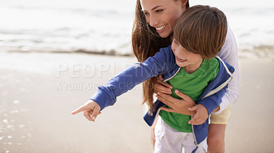 Buy stock photo Mother, child and pointing outdoor at beach for family travel or holiday in summer with a smile and fun. A woman and kid or son playing together on vacation at sea with love, care and happiness