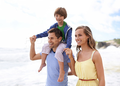 Buy stock photo Family, fun and happy while walking at beach for travel, fun or holiday in summer with a smile. Man, woman and child or son walk together outdoor on vacation at sea with happiness, love and care