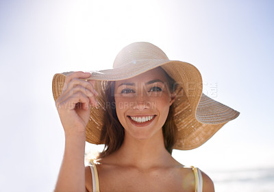Buy stock photo Woman, hat and portrait for smile at beach for holiday or getaway on weekend in sunlight for summer. Cheerful and happy person with hand and face in warm weather for outdoor on trip or vacation 
