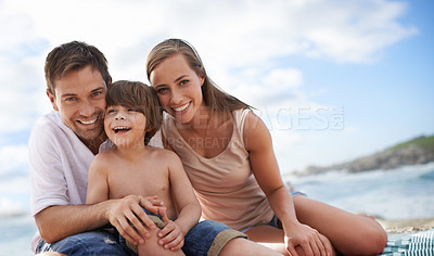 Buy stock photo Happy family, child and portrait at beach for travel holiday in summer with a smile and fun. A man, woman and kid or son together on vacation, adventure or picnic at sea with a blue sky and happiness