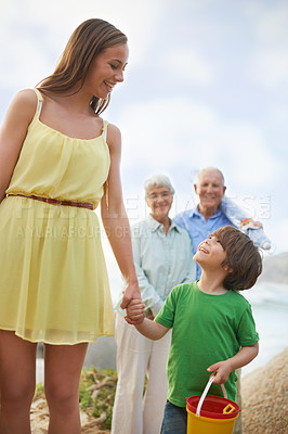 Buy stock photo Family, mom and kid holding hands on beach for vacation, adventure and tropical holiday in Australia. Grandparents, mother and happy face of boy child at ocean with love, weekend and smile in summer.