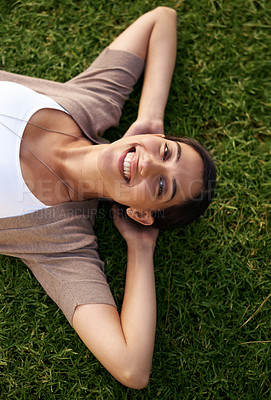 Buy stock photo Woman, relax and lying on grass while resting, above and enjoy summer or nature outdoor. Female person, smile and sunshine after holiday or vacation, calm lady and happiness in park or outside