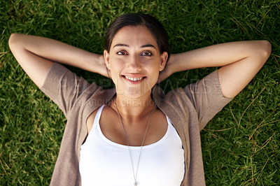 Buy stock photo Woman, relax and lying on grass in portrait with happiness in summer on vacation or holiday in Mexico. Girl, smile and calm break on lawn in backyard, garden or park with wellness in environment