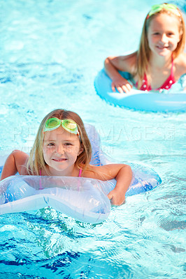 Buy stock photo Swimming, inflatables and portrait of kids in pool, playing and summer at resort on vacation. Holiday, games and friends relax in water with toys for fun, activity or children with safety gear