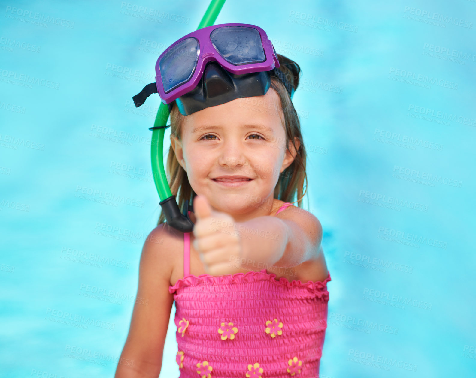 Buy stock photo A cute little girl showing a thumb's up while in her swimsuit at the pool