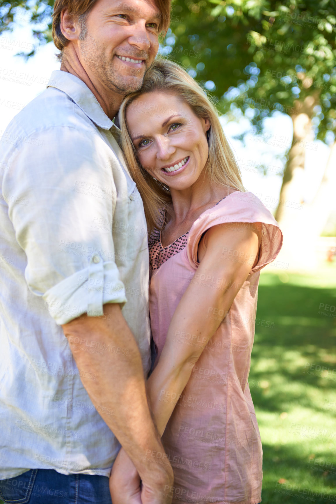 Buy stock photo Holding hands, nature and portrait of couple in park hugging for love, care and marriage on vacation. Happy, outdoor and man and woman embracing in garden on holiday or weekend trip for romantic date