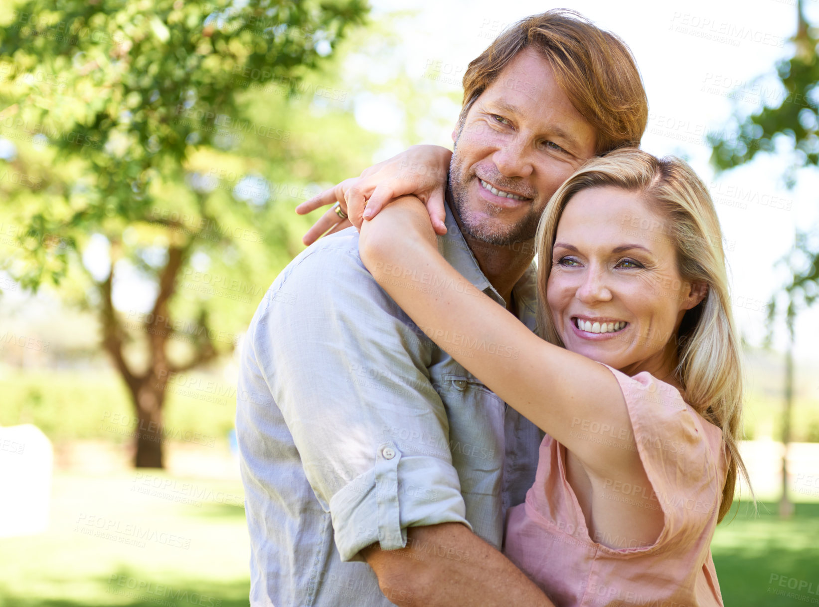 Buy stock photo Couple, care and hug in park for romance, travel and commitment in marriage or relationship on trip. Mature people, love and bonding on outdoor date in garden, support and embrace on summer holiday