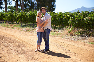Buy stock photo Couple, portrait or hug outdoor in countryside, wine farm or vineyard for love, care or holiday. People, husband and wife embrace together at winery, nature or environment with vines, plants or trees