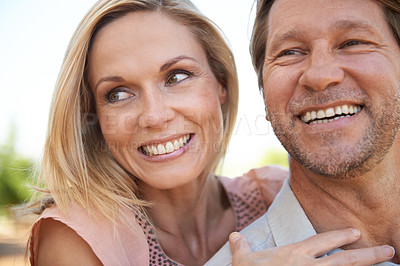 Buy stock photo Shot of a happy mature couple enjoying a day outdoors