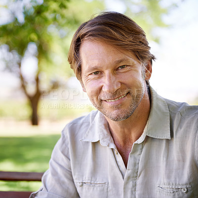 Buy stock photo Portrait of a handsome mature man enjoying a day in the park