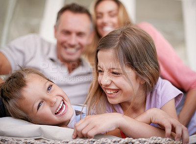 Buy stock photo Shot of a happy young family playing together