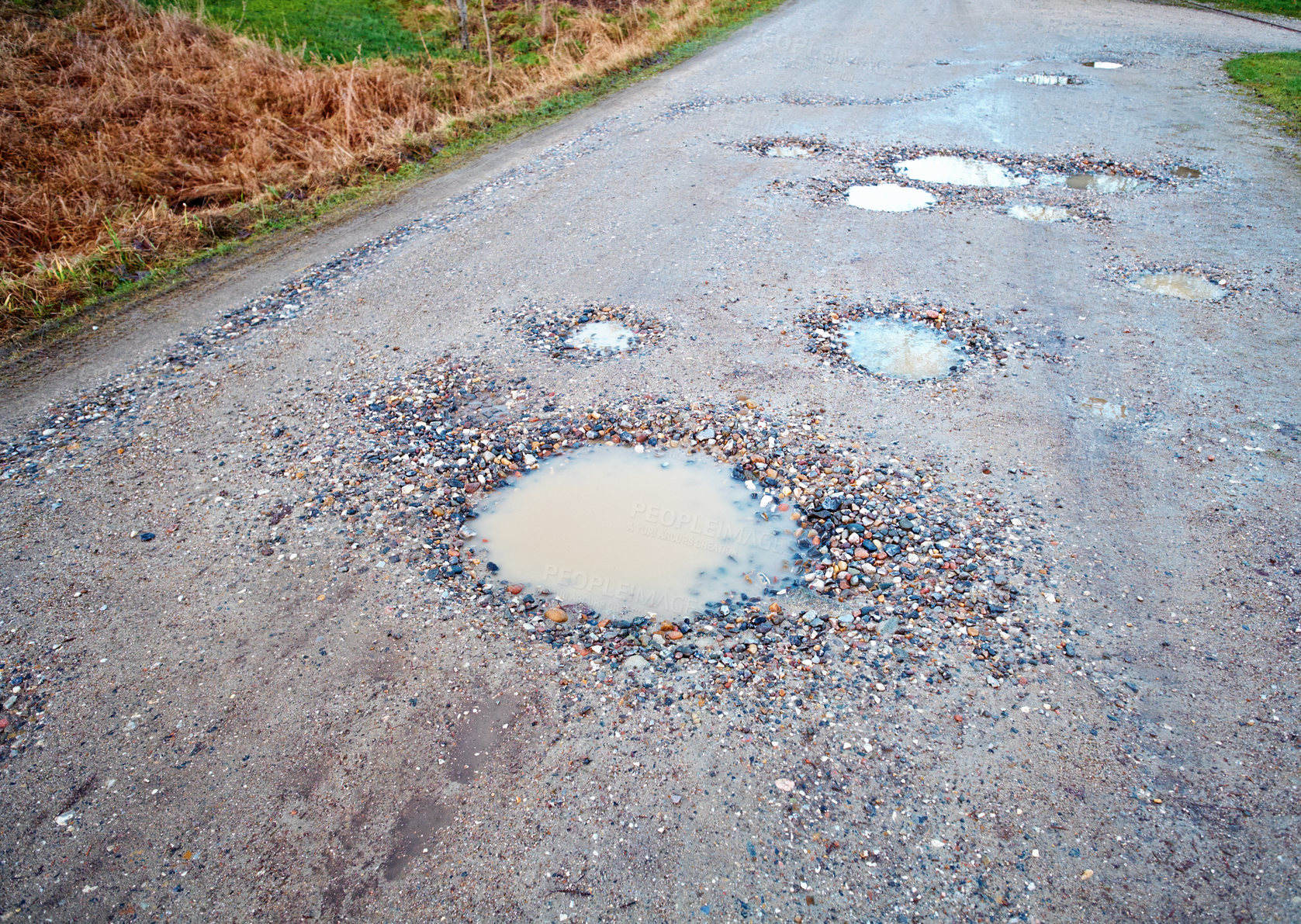 Buy stock photo Water, gravel and road in countryside with pothole with maintenance, infrastructure and farm transport in winter. Dirt, path and rain puddle in hole on rural street with damage, ground and nature.