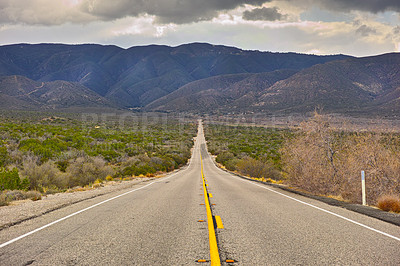 Buy stock photo Mountain, road trip and natural landscape for travel, holiday and scenery at Anza-Borrego Desert State Park in California. Nature, cloudy sky and highway for journey, vacation and outdoor adventure.