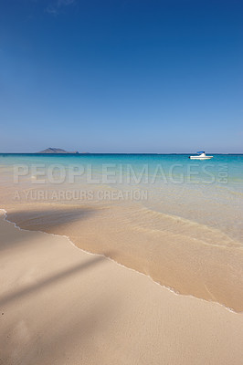 Buy stock photo Ocean, boat and blue sky for holiday, sand and rocks in Hawaii for peace and tranquility. Seaside, waves and summer for vacation, location and beach for clear water on travel and tropical trip 
