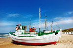 A photo of a Danish fishing boat at the beach