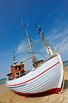 A photo of a Danish fishing boat at the beach