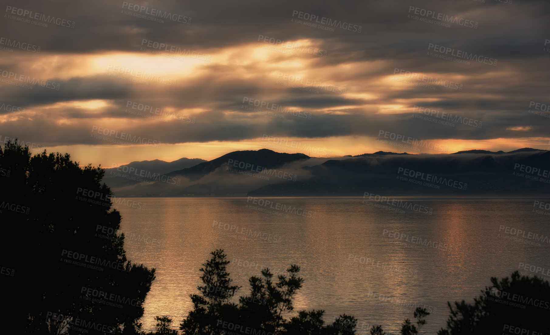 Buy stock photo Landscape, silhouette and ocean on sunset background for environment, weather and travel or adventure. View of empty sea or water in nature with clouds, winter and sunset in Wellington, New Zealand