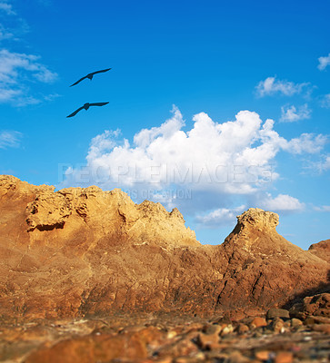 Buy stock photo Mountain, birds and natural landscape with blue sky, sun and calm clouds on peak at travel location. Nature, cliff and environment with earth, flight and holiday destination in wilderness with rocks