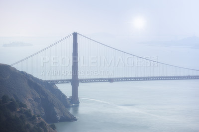 Buy stock photo Golden Gate bridge, fog and ocean at sunrise by road, infrastructure or architecture in nature. Street, highway and hill with rocks, sea or horizon in morning sunshine for transport in San Francisco