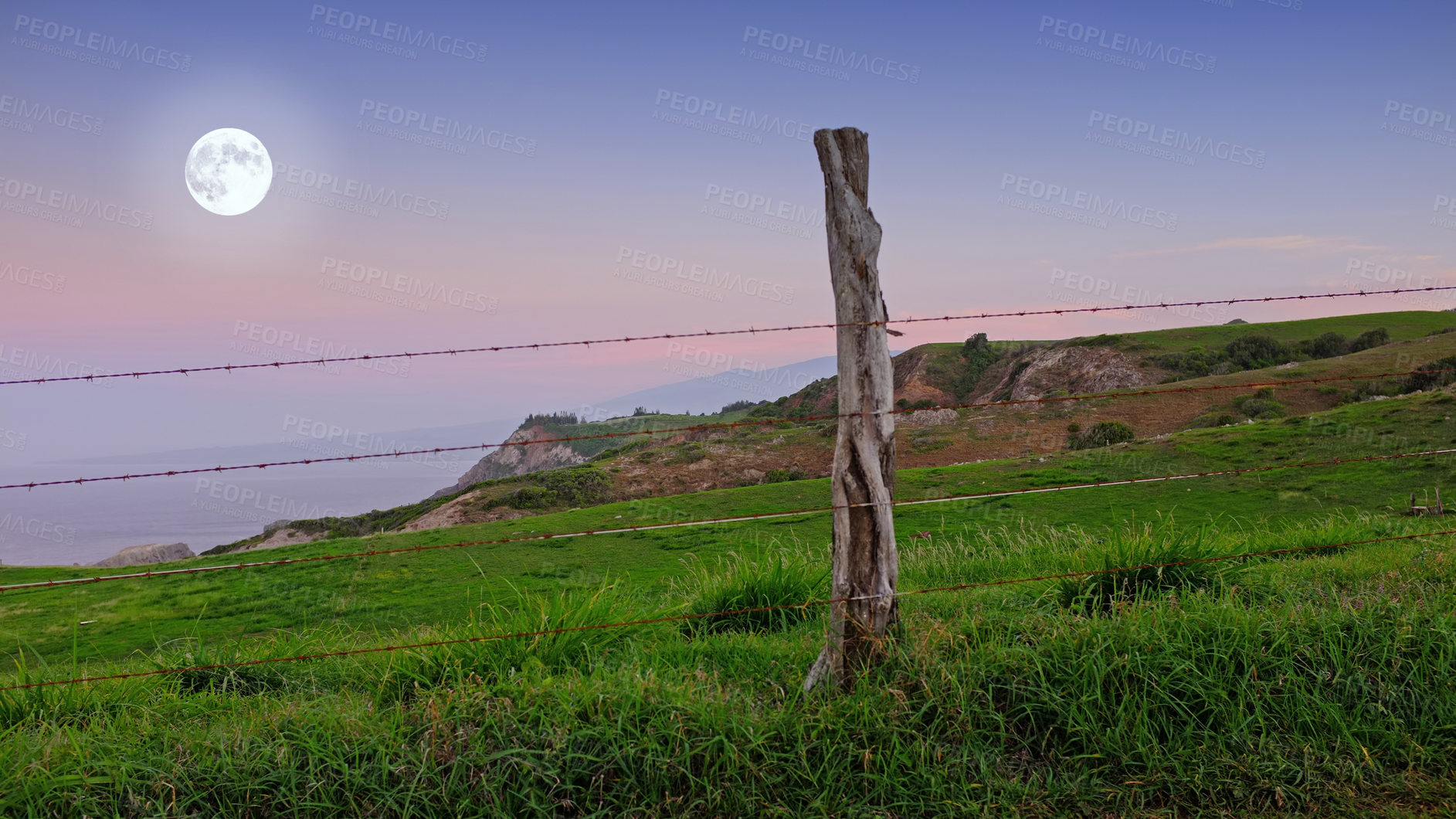 Buy stock photo Hawaii, landscape and hill in countryside with fence, wood and nature with peace for life. Field, meadow and sky with moon, outdoor and location with environment for vacation on holiday to relax