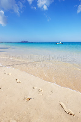 Buy stock photo Ocean, Bali and blue sky for holiday, sand and rocks in shore for peace and tranquility. Seaside, waves and summer for vacation, location and beach for clear water on travel and tropical trip 