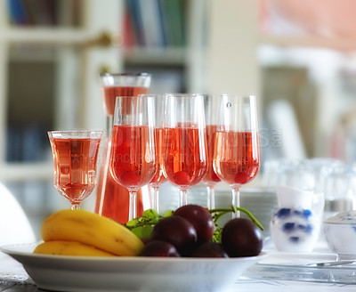 Buy stock photo Red, wine and fruit bowl in home, table with alcohol drink and glasses for guests. Hostess and preparation for celebration, events and holiday culture for relax with sangria for cocktail party