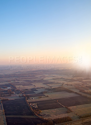 Buy stock photo Town, aerial view and countryside in outdoors at sunset, field and sustainable environment on travel. Blue sky, peace and mockup space in nature, drone and town for ecosystem at dusk or landscape