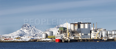 Buy stock photo Fishing, plant and industrial tank on water for processing, production and feed mill for fish industry in Norway. Manufacturing, containers and warehouse for agriculture and sea factory with blue sky