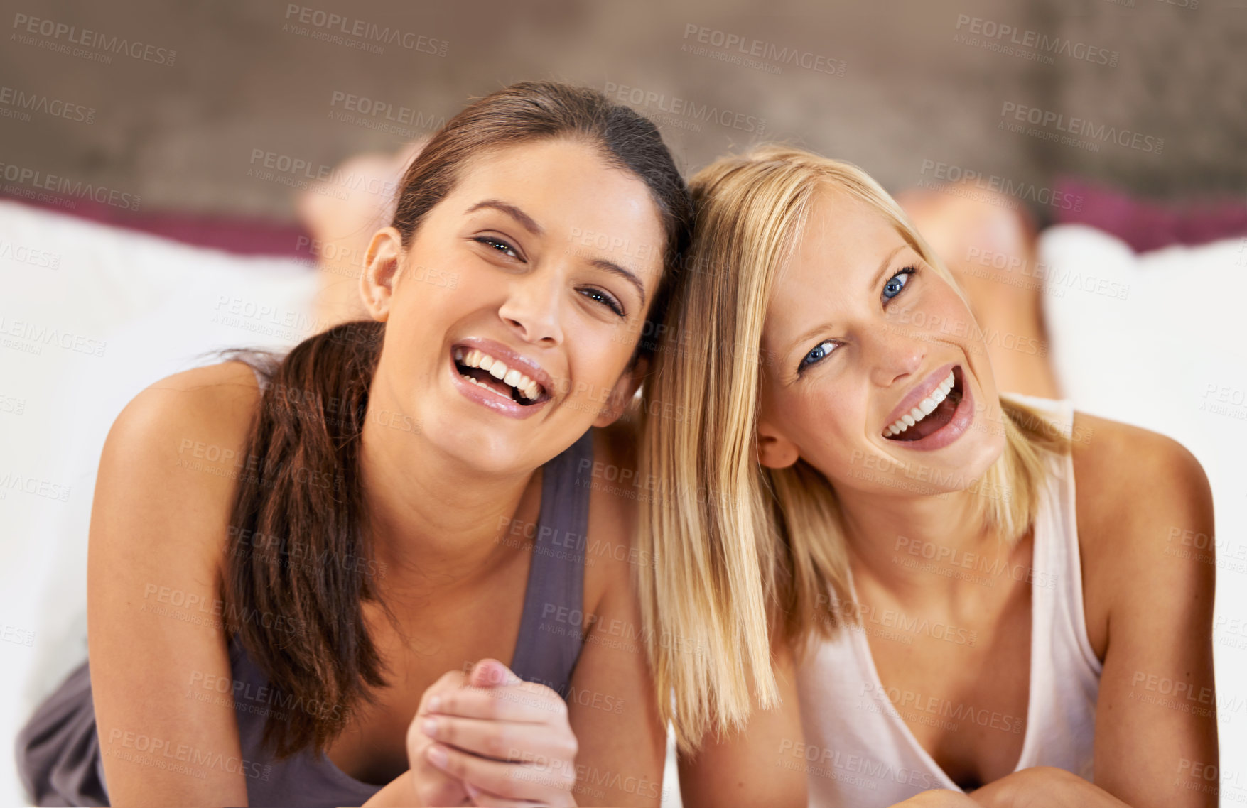 Buy stock photo Happy, portrait and women on a bed with support, trust or care while bonding in their home together. Face, smile and friends in a bedroom for staycation fun, chilling or enjoying weekend in a house