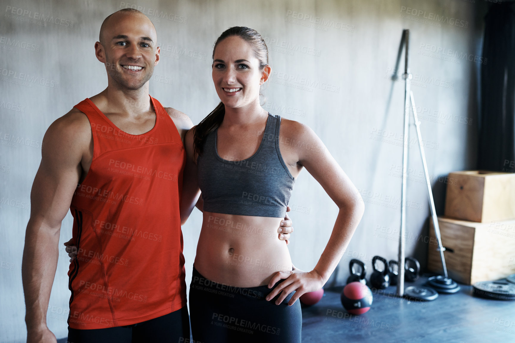 Buy stock photo Portrait of a young couple training together at the gym
