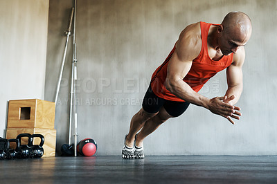 Buy stock photo Shot of a man doing exercises at the gym