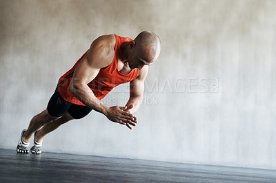 Buy stock photo Shot of a man doing exercises at the gym