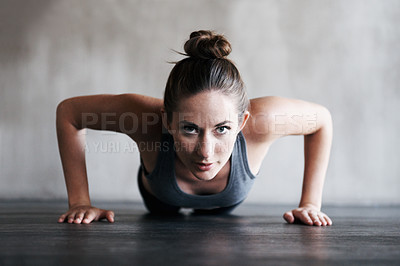 Buy stock photo Shot of a woman doing pushups at the gym