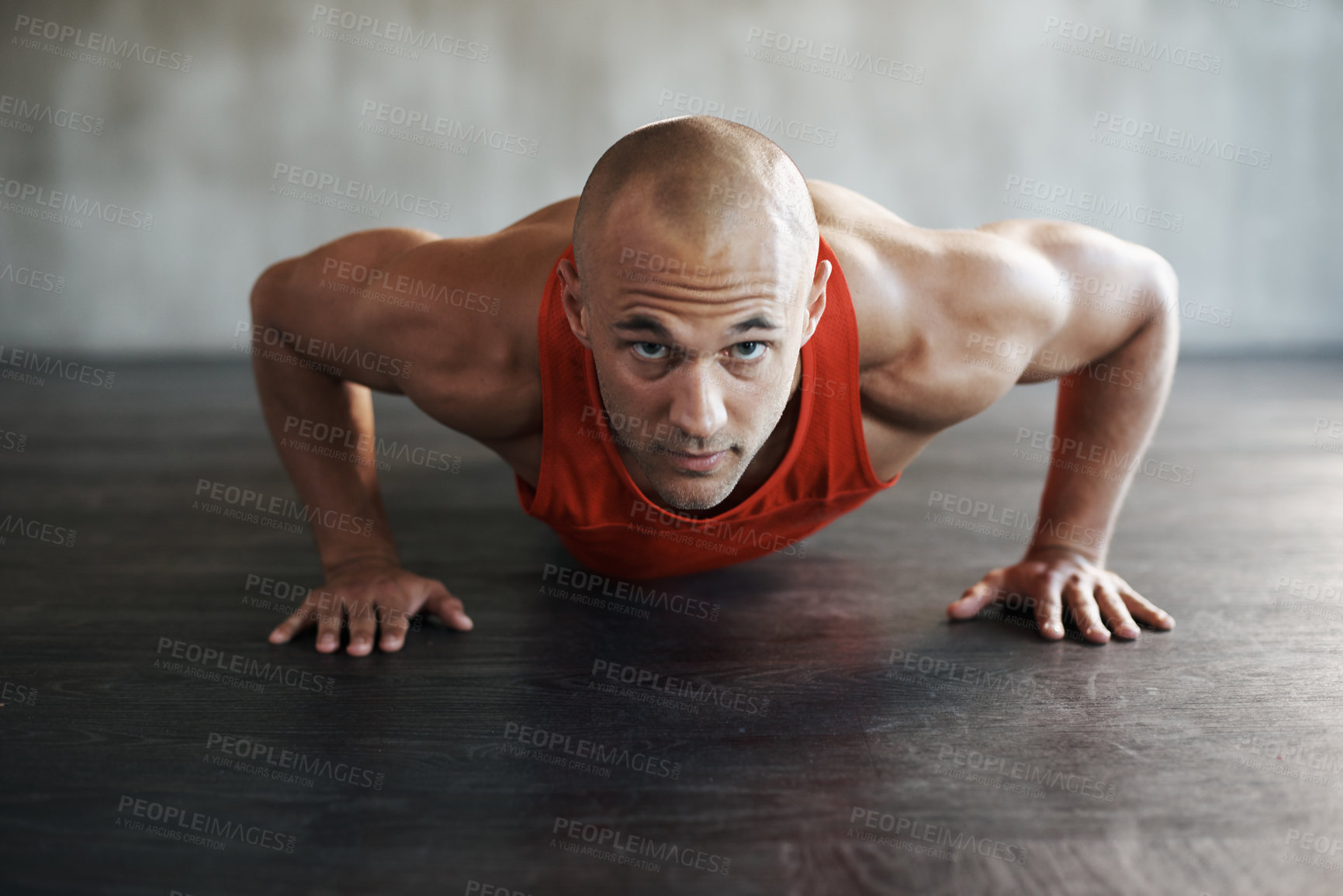 Buy stock photo Shot of a man doing pushups at the gym