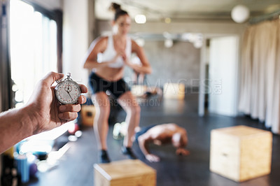 Buy stock photo Exercise, people and hand of coach with timer for gym workout, muscle training or health cardio. Clock, sports fitness and team exercise challenge with personal trainer recording stopwatch time