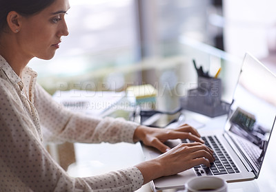 Buy stock photo Shot of a beautiful young woman working on her laptop