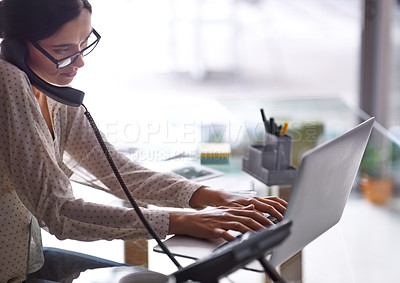 Buy stock photo Shot of a beautiful young businesswoman working at her desk