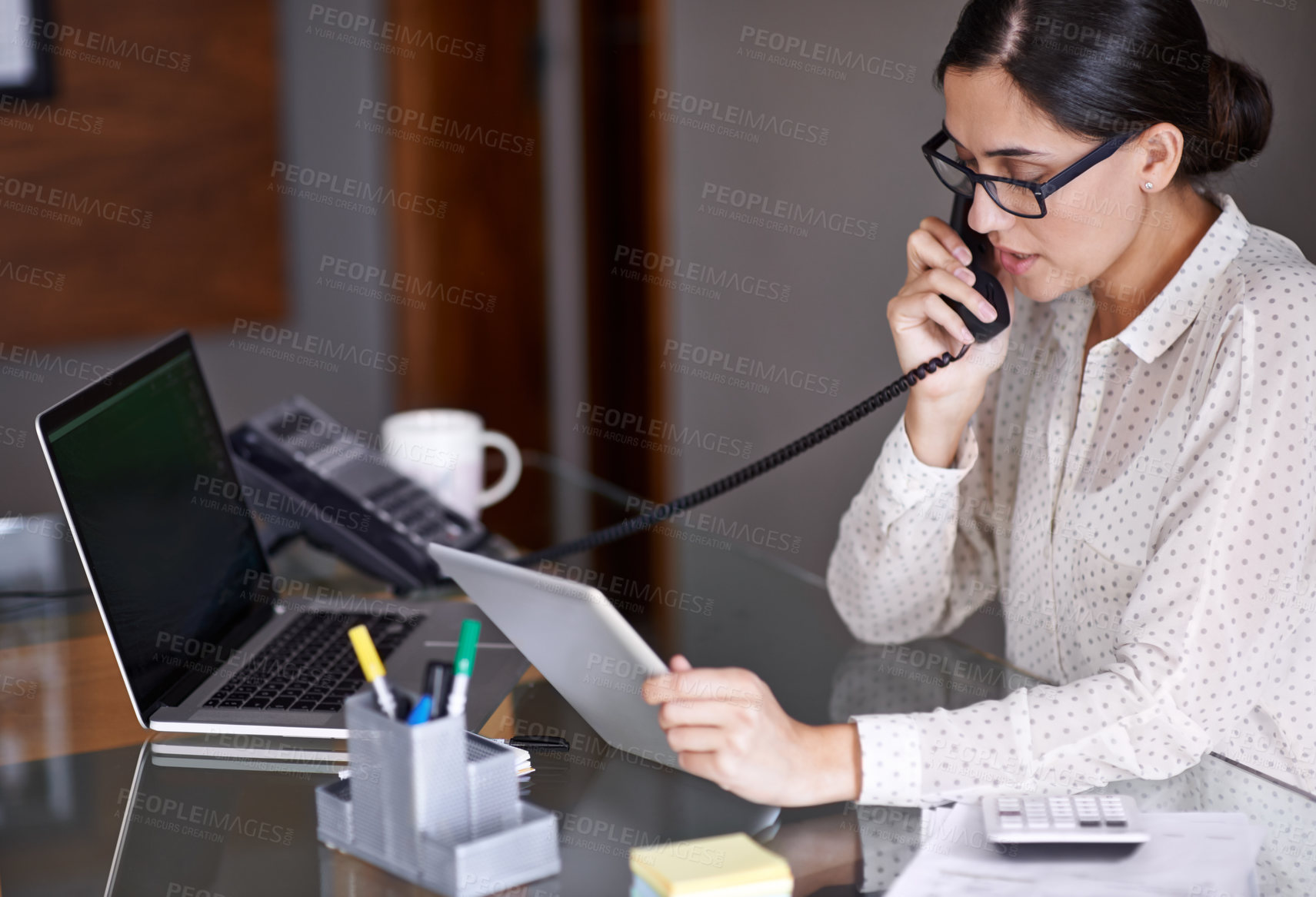 Buy stock photo Telephone, tablet and businesswoman on a call in the office doing research on the internet. Technology, landline and professional female employee working on corporate project with mobile in workplace