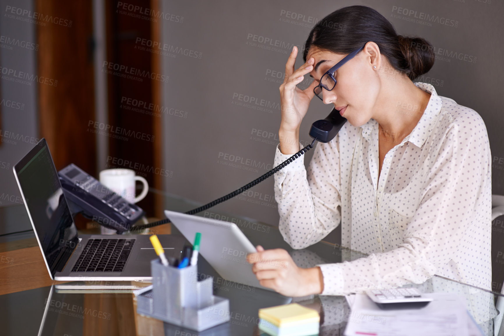 Buy stock photo Businesswoman, phone call and stressed in office, desk and on landline with client. Technology, computer and tablet touch screen for financial advisor, conversation and communication on budget