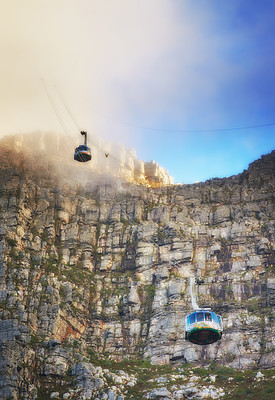 Buy stock photo Nature, clouds and blue sky with aerial cable car on Table Mountain for outdoor adventure, travel destination and sightseeing. Low angle, national landmark and tourism for peace, calm and relax.