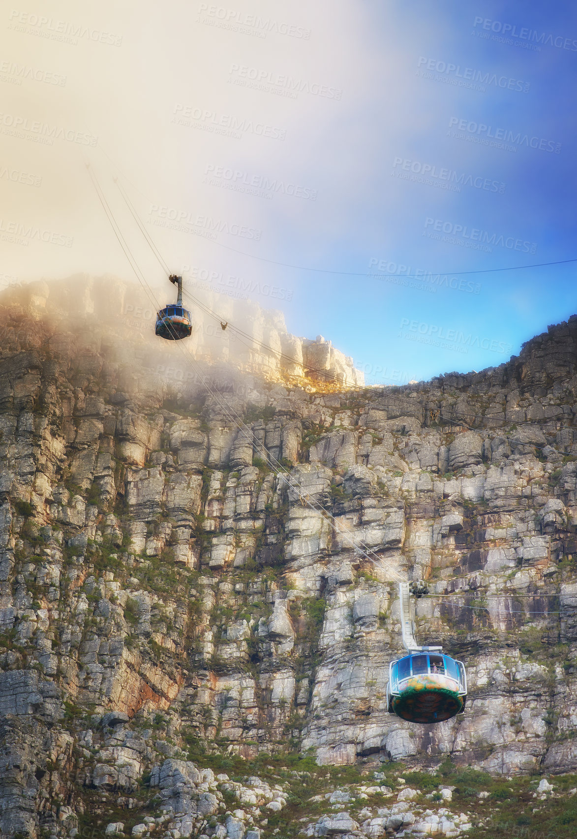 Buy stock photo Nature, clouds and blue sky with aerial cable car on Table Mountain for outdoor adventure, travel destination and sightseeing. Low angle, national landmark and tourism for peace, calm and relax.