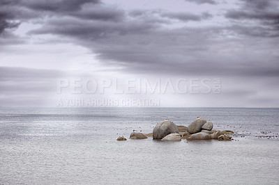 Buy stock photo Sky, clouds and ocean with rocks for travel, vacation or holiday in nature by tropical island. Seascape, paradise and sea with stones by beach for outdoor scenic summer weekend trip in Cape town.